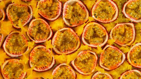 Photo for Fresh sliced passion fruits falling into juice, top view - Royalty Free Image