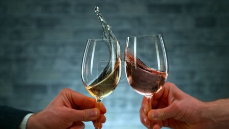 Photo for Freeze Motion Shot of Clinking Two Glasses of Wine, Close-up - Royalty Free Image