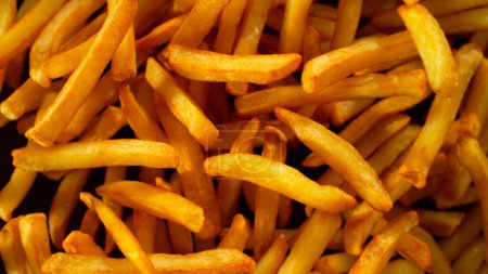 Photo for Freeze Motion Shot of Flying Fresh French Fries, Close-up - Royalty Free Image