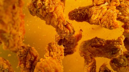Foto de Freeze Motion Shot of Flying Fresh Fried Chicken Wings or Strips, Primer plano - Imagen libre de derechos