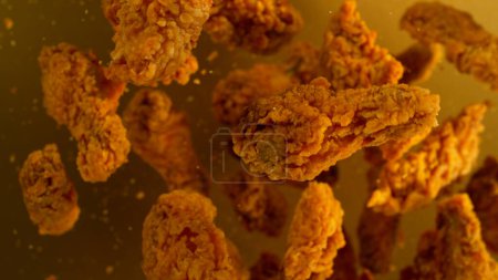 Foto de Freeze Motion Shot of Flying Fresh Fried Chicken Wings or Strips, Primer plano - Imagen libre de derechos