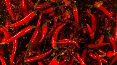 Photo for Chilli peppers flying up in the air. Freeze motion. Isolated on black background. - Royalty Free Image