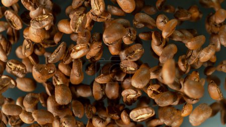 Photo for Freeze Motion Shot of Flying and Rotating Coffee Beans, Dark Background - Royalty Free Image