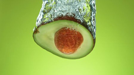 Photo for Freeze motion of falling fresh avocado into water - Royalty Free Image