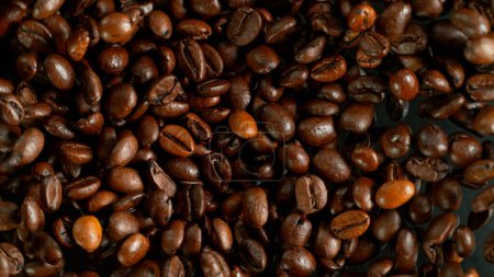 Photo for Freeze Motion Shot of Flying and Rotating Coffee Beans, Dark Background - Royalty Free Image