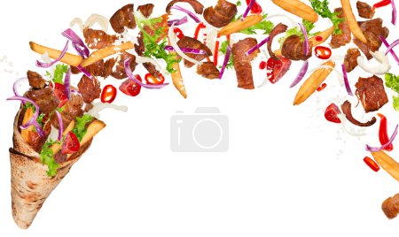 Téléchargez les photos : Gros plan sur le sandwich kebab avec des ingrédients volants. Bouge pas.
. - en image libre de droit