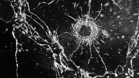 Photo for Close-up of gunshot through the glass, shattering against the black background - Royalty Free Image