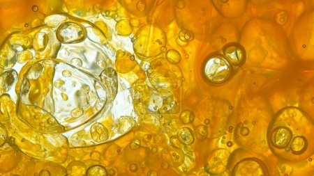 Freeze Motion Shot of Moving Oil Bubbles on Golden Background