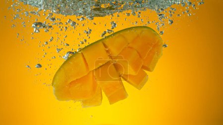 Photo for Freeze motion of falling fresh mango fruit into water - Royalty Free Image