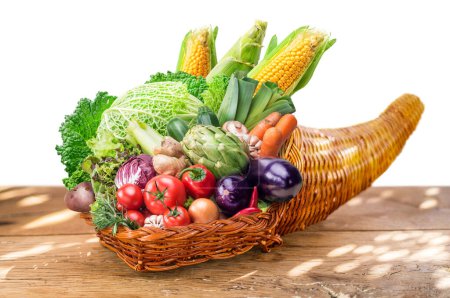Photo for Horn of plenty with fresh organic vegetables and herbs as a symbol of autumn gifts. File contains clipping path. - Royalty Free Image