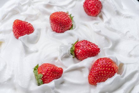 Photo for Fresh strawberries in the yoghurt or cream. Top view. - Royalty Free Image