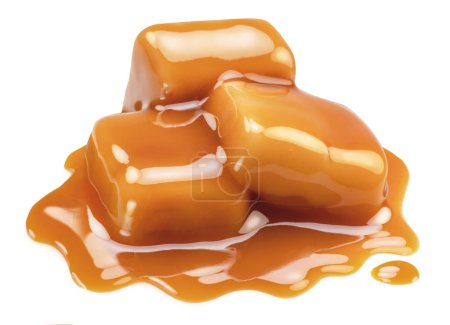 Foto de Caramel candies in milk caramel sauce isolated on white background. - Imagen libre de derechos