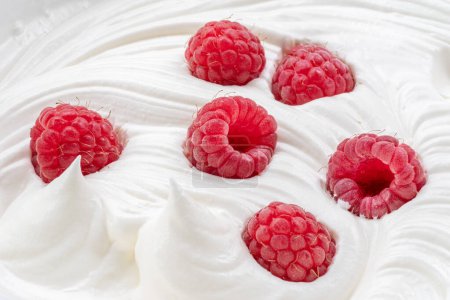 Photo for Fresh raspberries in the yoghurt or cream. Top view. - Royalty Free Image