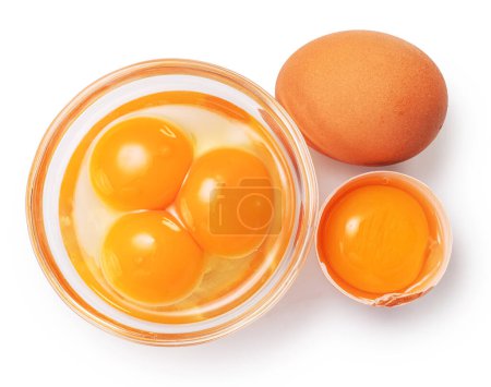 Photo for Brown chicken egg and egg yolks in glass bowl on white background. Clipping path. - Royalty Free Image