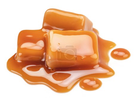 Caramel candies in milk caramel sauce isolated on white background.