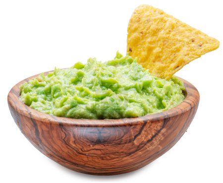 Photo for Guacamole bowl and corn chips dipped in it on white background. Top view. File contains clipping path. - Royalty Free Image