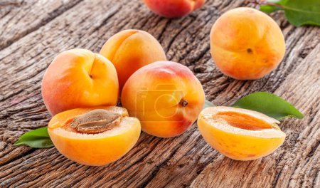 Photo for Ripe apricots on old wooden table. - Royalty Free Image