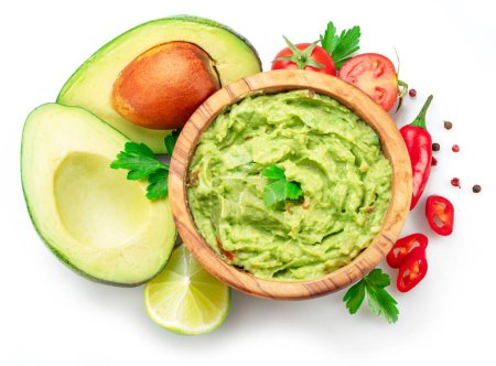 Photo for Guacamole bowl and guacamole ingredients isolated on white background. Flat lay. - Royalty Free Image
