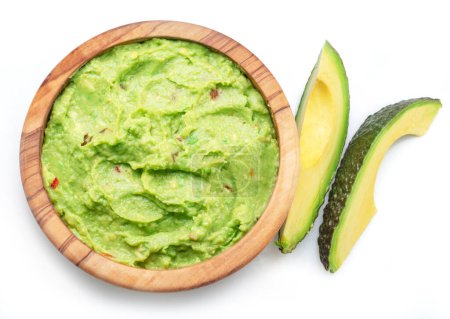 Photo for Guacamole sauce and slices of avocado fruit isolated on white background. - Royalty Free Image