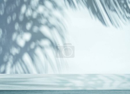 Photo for Blurred shadow of tropical palm leaves on the wall and table top in the foreground. Summer concept. - Royalty Free Image