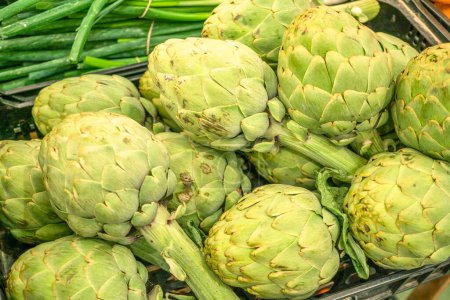 Photo for Green french artichoke flowers buds on the farm market stall. - Royalty Free Image
