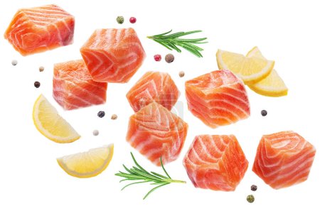 Photo for Fresh salmon pieces, seasonings  and lemon slices levitating in air on white background. File contains clipping paths. - Royalty Free Image