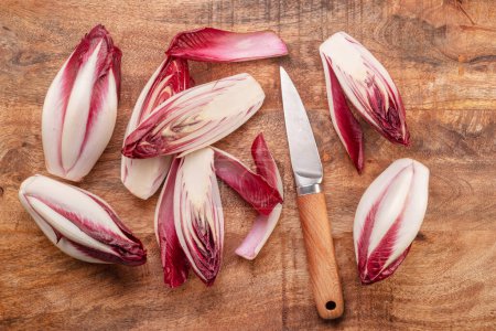 Photo for Red endive slices on wooden background. Top view. - Royalty Free Image