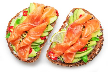 Photo for Salmon toasts with avocado isolated on white background. Top view. - Royalty Free Image