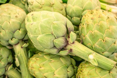 Photo for Green french artichoke flowers buds on the farm market stall. - Royalty Free Image