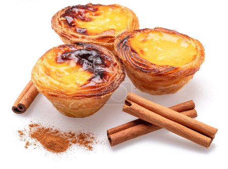 Photo for Pastel de nata tarts  and cinnamon sticks isolated on white background. - Royalty Free Image