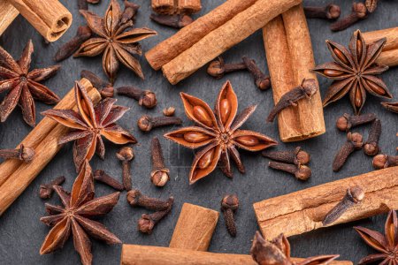 Photo for Lots of three spices for mulled wine star anise, cinnamon and clove, macro. Great background for your projects. - Royalty Free Image