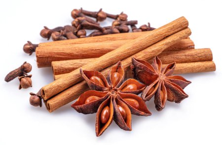 Photo for Lots of three spices for mulled wine star anise, cinnamon and clove on a white background. Great spices background for your projects. - Royalty Free Image