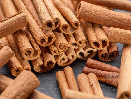 Photo for Cinnamon sticks against the background of a gray stone table. Nice spices cinnamon background for your projects. - Royalty Free Image