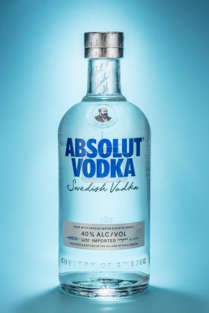 Photo for Portugal, Lisbon, December, 21, 2023: Bottle of Swedish vodka Absolut, isolated on a blue background. Vodka Absolut - one of the most popular brands of vodka in the world, produced since 1879 in southern Sweden. - Royalty Free Image