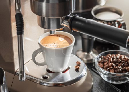 Photo for Automatic coffee machine. Pouring coffee into the coffee cup closeup. - Royalty Free Image
