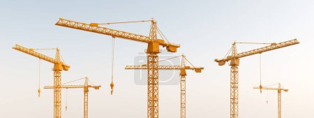Photo for Construction cranes against a cloudless sky - Royalty Free Image