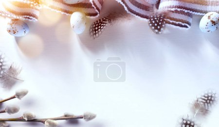 Photo for Easter border frame of Easter eggs and spring flowers on holidays table with copy space in the middle - Royalty Free Image