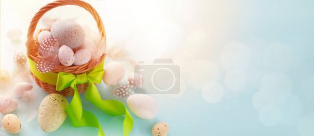 Foto de Feliz Pascua, huevos pintados de Pascua en la cesta en la mesa rústica de madera para su saludo en vacaciones. espacio de copia - Imagen libre de derechos