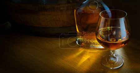 Photo for Brandy glass; bottle and barrel; luxurious men's club banner background with copy space - Royalty Free Image