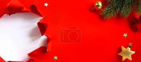 Photo for Christmas holidays banner design. Christmas tree branch decorated golden color balls and stars on red background. Wide Xmas greeting card mockup, header, flyer - Royalty Free Image