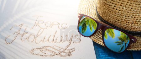Photo for Abstract tropical holiday, tropic holidays banner. sand beach from above with straw bucket hat and sunglasses, palm trees reflection, summer vacation concept banner with copy spac - Royalty Free Image
