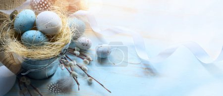 Photo for Happy Easter;  Easter eggs on blue table background - Royalty Free Image