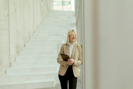 Photo for Businesswoman with digital tablet on the modern office hallway - Royalty Free Image