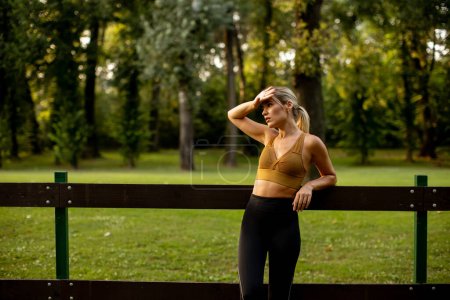 Photo for Pretty young woman resting after the outdoor training - Royalty Free Image