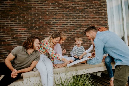 Photo for Happy group of young people and kids eating pizza in the house backyard - Royalty Free Image