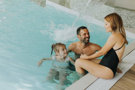 Photo for Family enjoy in the indoor swimming pool - Royalty Free Image