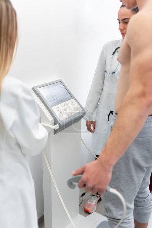 Photo for A doctor in a white coat uses a modern medical device to perform a health checkup. - Royalty Free Image