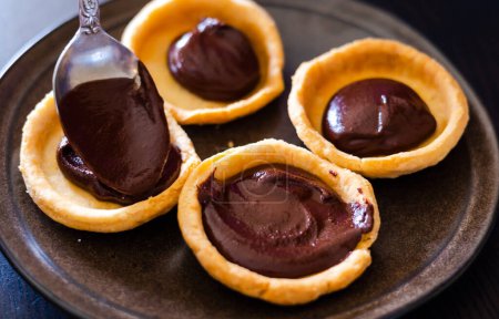 Photo for Chocolate-Filled Mini Tarts Close-Up - Royalty Free Image