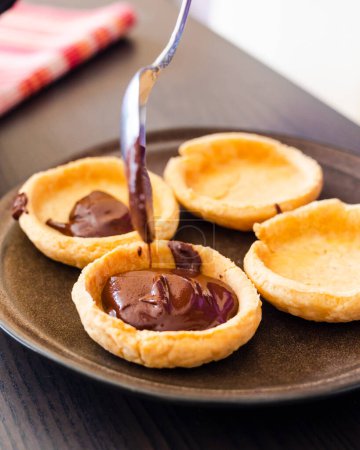 Photo for Chocolate-Filled Mini Tarts Close-Up - Royalty Free Image