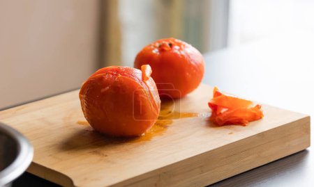 Foto de Perfección de pelado: Tomates frescos en el primer plano de madera - Imagen libre de derechos